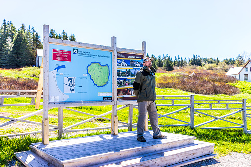 Perce: Bonaventure Island Park entrance in Gaspe Peninsula, Quebec, Gaspesie region with ranger standing by map and signs