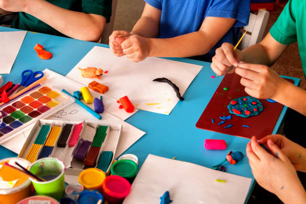 istock Plasticine modeling clay in children class. Teacher teaches in school. 826843530
