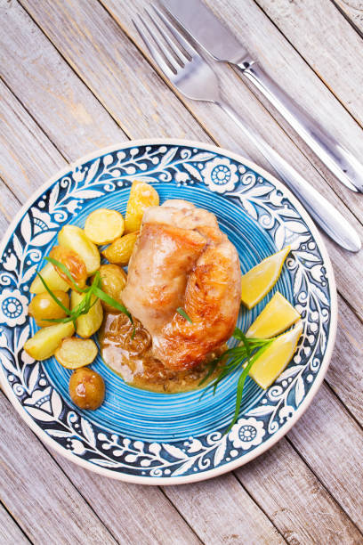 istock Rabbit with potatoes and lemon in cream sauce, garnished with tarragon 826846972