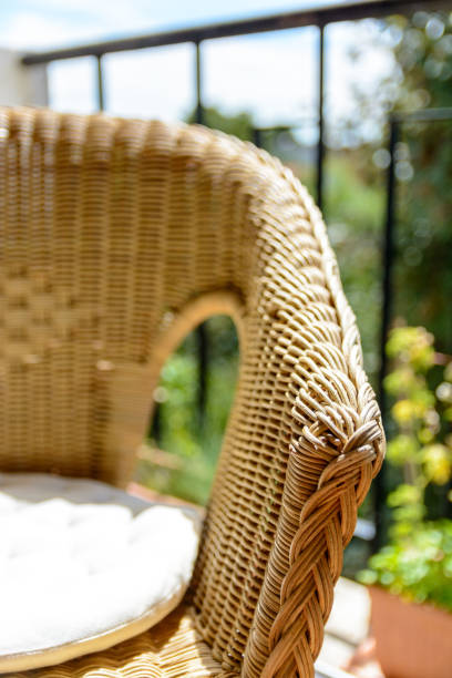 istock A rattan chair with a white cushion on a balcony 826847166