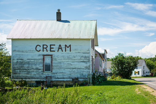 The town name of Cream posted on the side of a small house in tiny Cream, Wisconsin