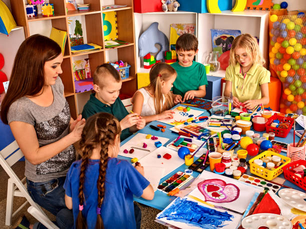 istock Plasticine modeling clay in children class. Teacher teaches in school. 826854662