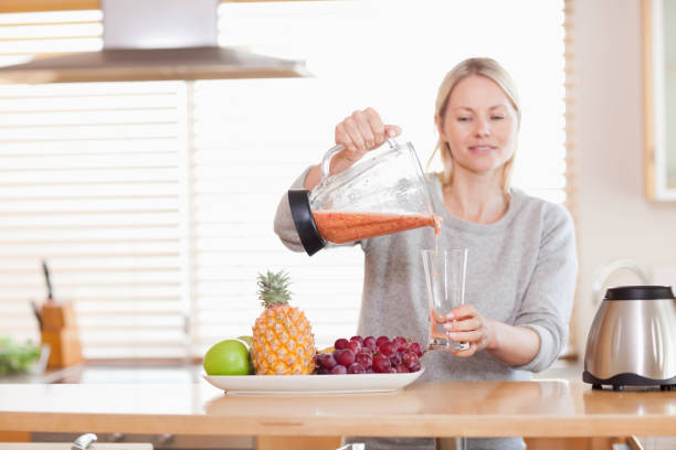istock Woman pouring self made juice into a glass 826854722