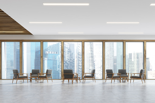 Waiting room room of a modern office with panoramic windows with light wooden frames and gray comfortable armchairs standing in threes. 3d rendering, mock up