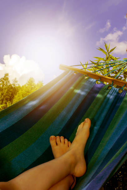 Kid is relaxing and swinging in a hammock