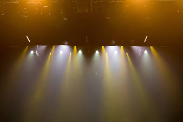 istock scene, stage light with colored spotlights and smoke 826859946
