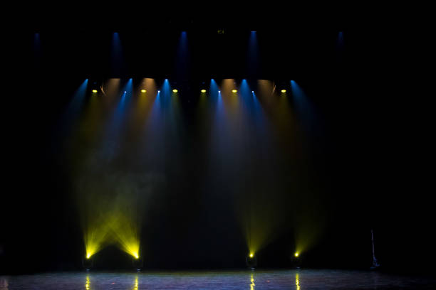 istock scene, stage light with colored spotlights and smoke 826860092