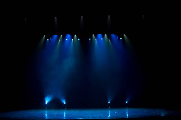 istock scene, stage light with colored spotlights and smoke 826860108