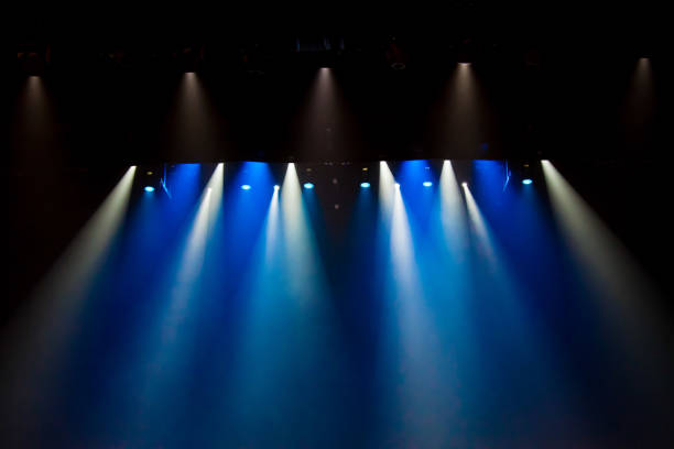 istock scene, stage light with colored spotlights and smoke 826860126
