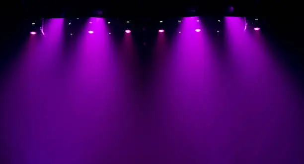 Photo of scene, stage light with colored spotlights and smoke