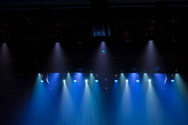 istock scene, stage light with colored spotlights and smoke 826862456