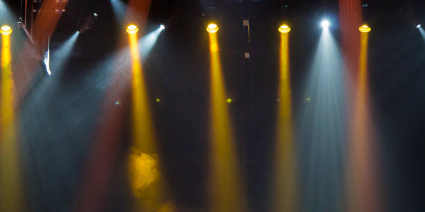 istock scene, stage light with colored spotlights and smoke 826862572