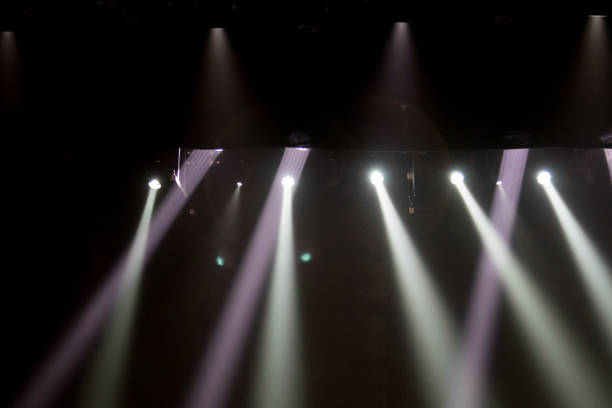 istock scene, stage light with colored spotlights and smoke 826862600