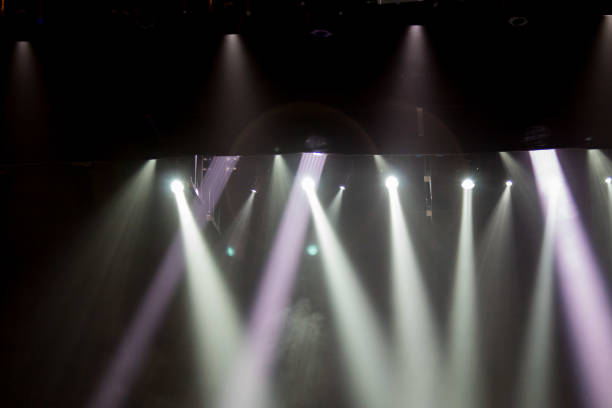 istock scene, stage light with colored spotlights and smoke 826862626