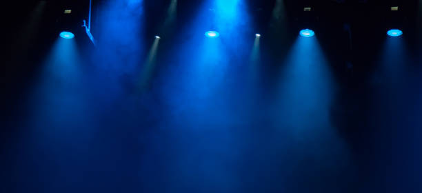 istock scene, stage light with colored spotlights and smoke 826862660