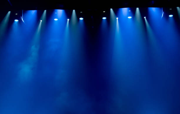 istock scene, stage light with colored spotlights and smoke 826862750