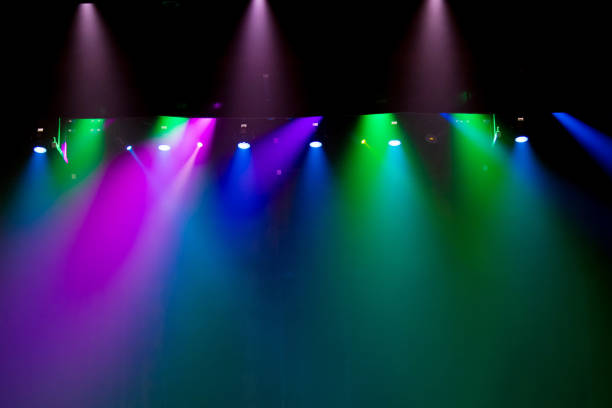 istock scene, stage light with colored spotlights and smoke 826865220