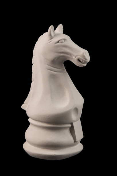 istock plaster figurine chess piece, horse, black background 826873130