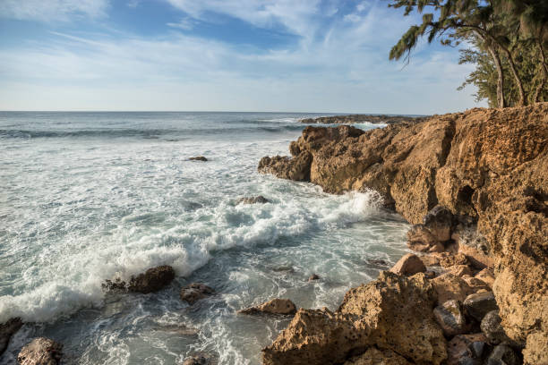 Waves crash on the rocks of Three Tables Beach on the Pacific Ocean North Shore in Oahu Hawaii USA