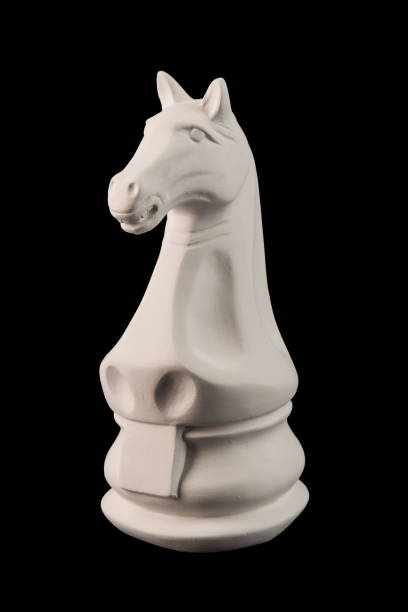 istock plaster figurine chess piece, horse, black background 826873158