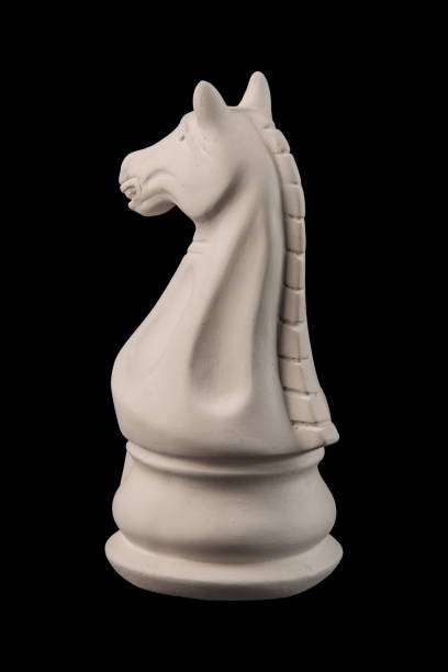 istock plaster figurine chess piece, horse, black background 826873190