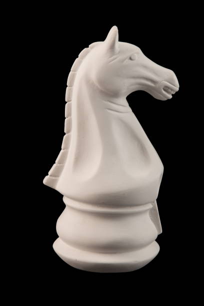 istock plaster figurine chess piece, horse, black background 826873244
