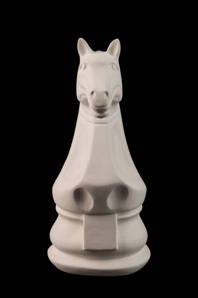 istock plaster figurine chess piece, horse, black background 826873250