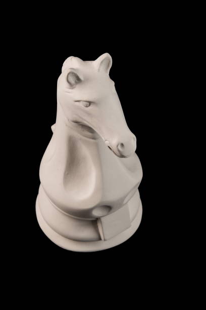 istock plaster figurine chess piece, horse, black background 826873264