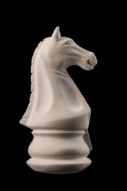istock plaster figurine chess piece, horse, black background 826873298