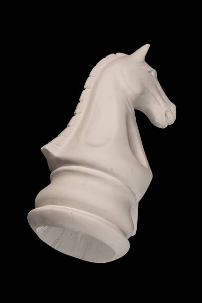 istock plaster figurine chess piece, horse, black background 826873400