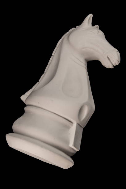 istock plaster figurine chess piece, horse, black background 826875466