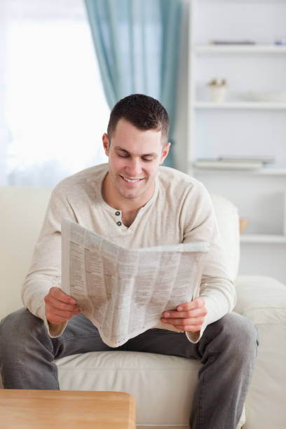 istock Portrait of a handsome man reading a newspaper 826888370