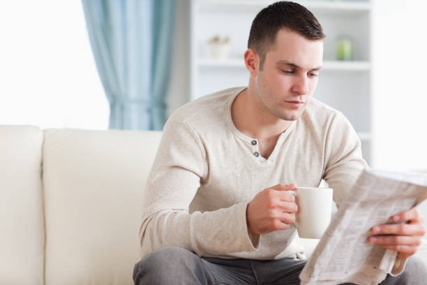 istock Calm man having a tea while reading the news 826888650
