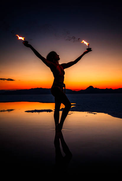 istock Woman Fire Dancer at the Salt Flats During Sunset 826901734