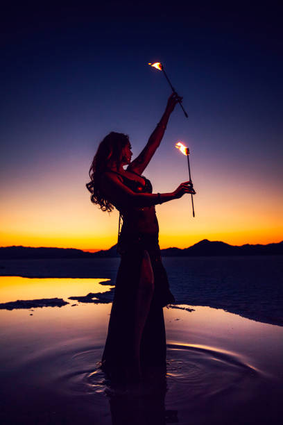 istock Woman Fire Dancing at Sunset 826906570