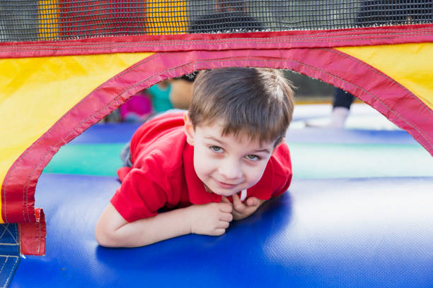 istock Little boy playing in bounce house 826906876