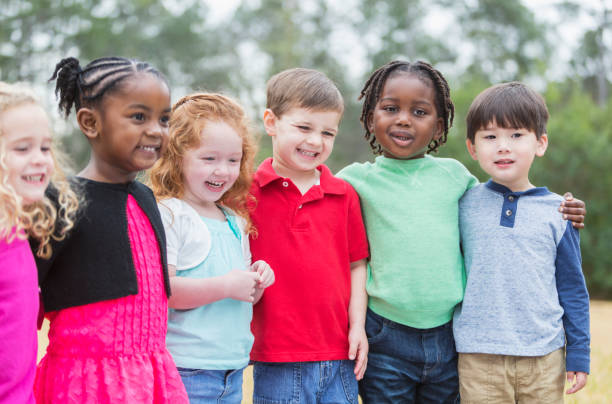 istock Multi-ethnic group of young children standing in a row 826906908