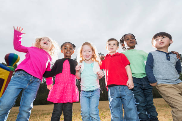 istock Multi-ethnic group of young children standing in a row 826906980