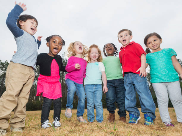 istock Multi-ethnic group of young children standing in a row 826907088