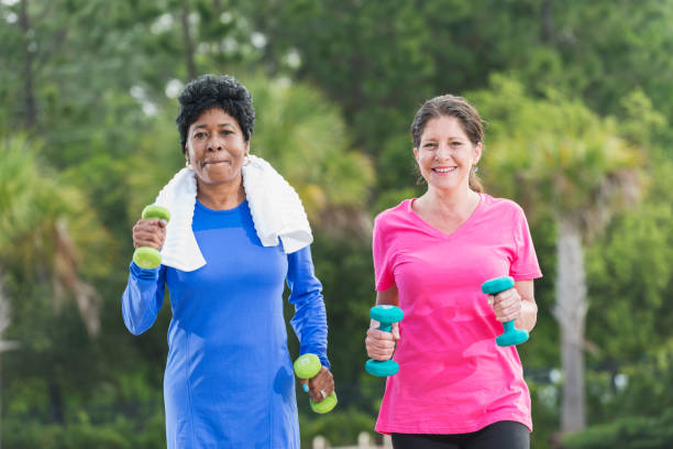istock Two mature women in the park exercising 826909462