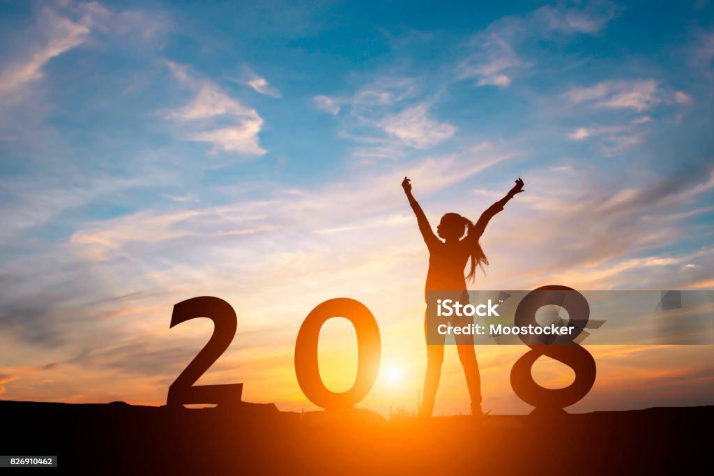 Silhouette of happy woman with New yeay 2018 concept in sunset background. New Stock Photo