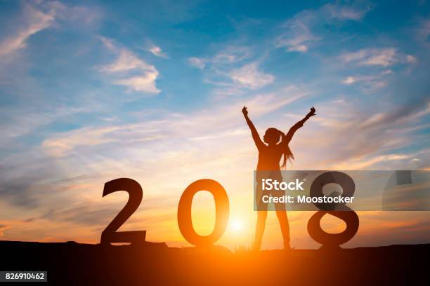 Silhouette Of Happy Woman With New Yeay 2018 Concept In Sunset Background Stock Photo - Download Image Now