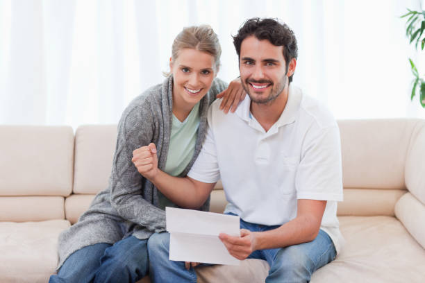 istock Delighted couple reading a letter 826917948