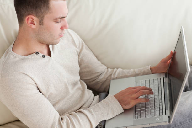 istock Good looking man relaxing with a laptop 826920720