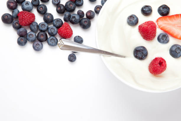 istock Bowl of cream with berries and a spoon 826924108