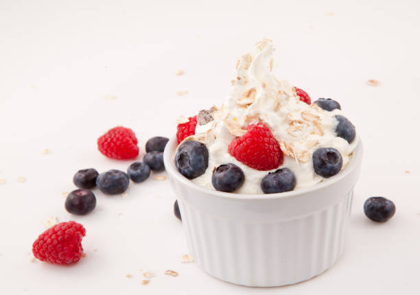 istock White jar of berries and whipped cream 826924634