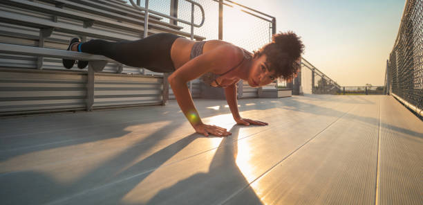 istock Woman strength training on bleachers 826925506