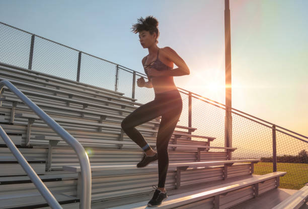 istock Woman jumping down bleachers 826928058
