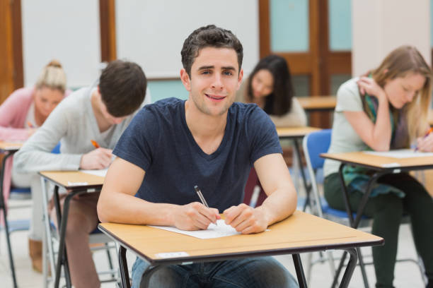 istock Man looking up from exam and smiling 826928232
