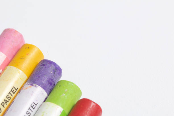 istock Colorful crayons pastels lie in a row. On a white background. View from above. 826928812